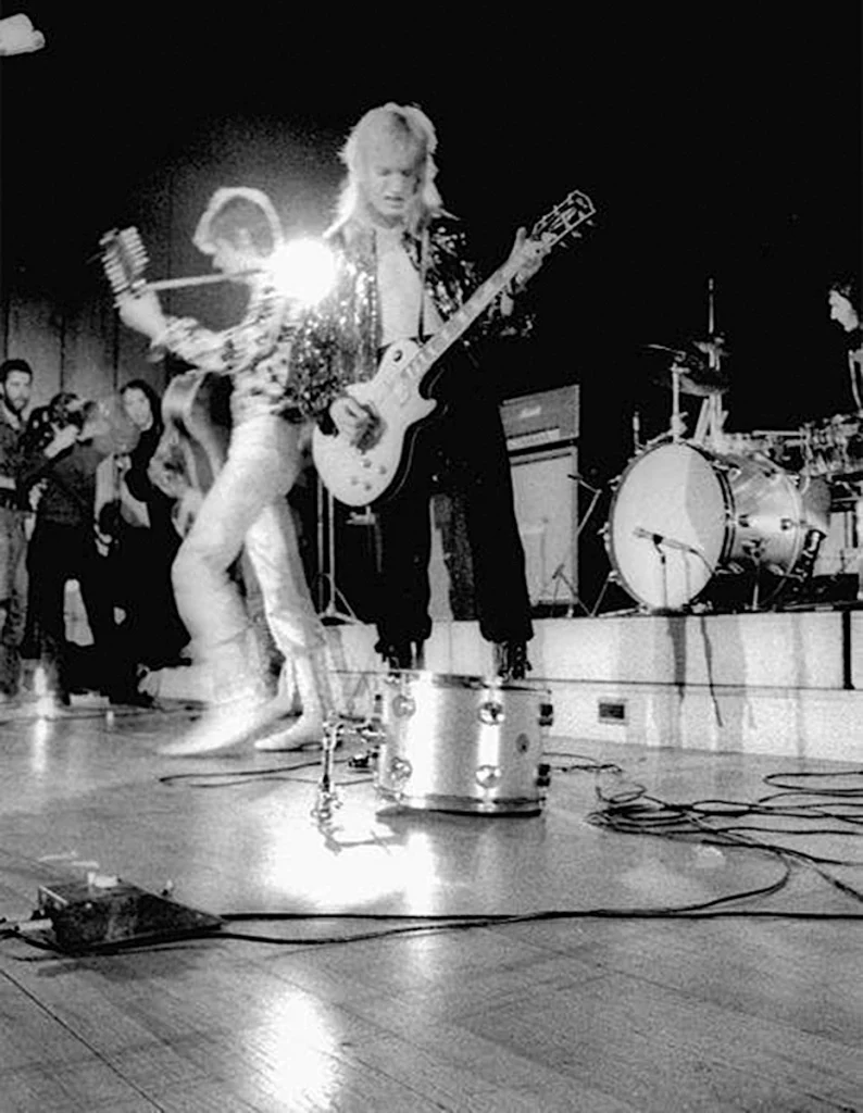 David Bowie & the Spiders from Mars, featuring Mick Ronson, performing at Imperial College London in 1972 with a Tone Bender MKI. (Photo credit unknown)